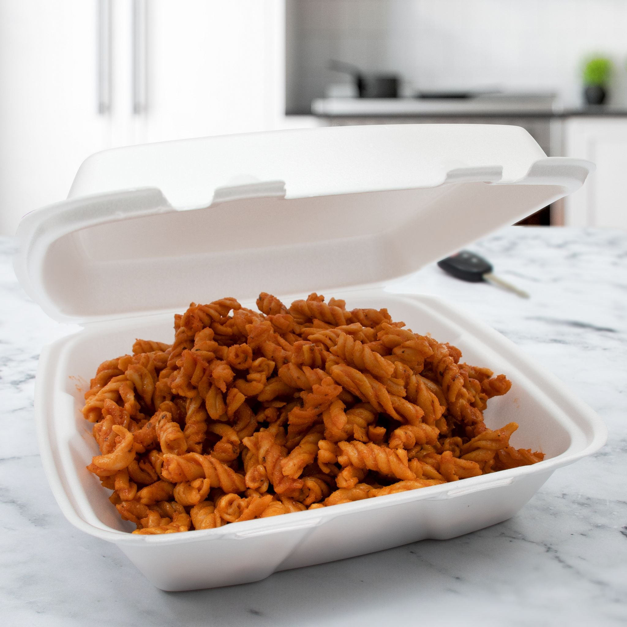 Dart 90HT1R foam hinged takeout container holding a prepared meal