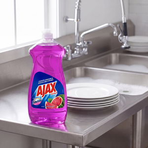 Ajax with Fabuloso Watermelon dish liquid 12.4 oz. bottle on the drainboard of a stainless steel commercial kitchen sink