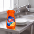 Ajax Ultra Triple Action Orange dish liquid 145 oz. jug on the drainboard of a stainless steel commercial kitchen sink