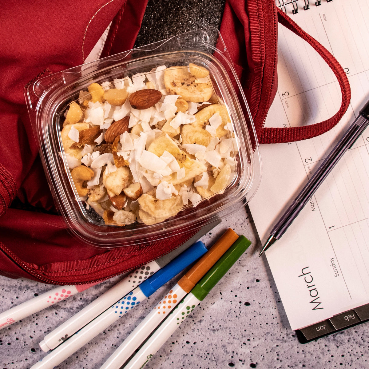Dart CH12DEF SafeSeal container holding trail mix in a red backpack