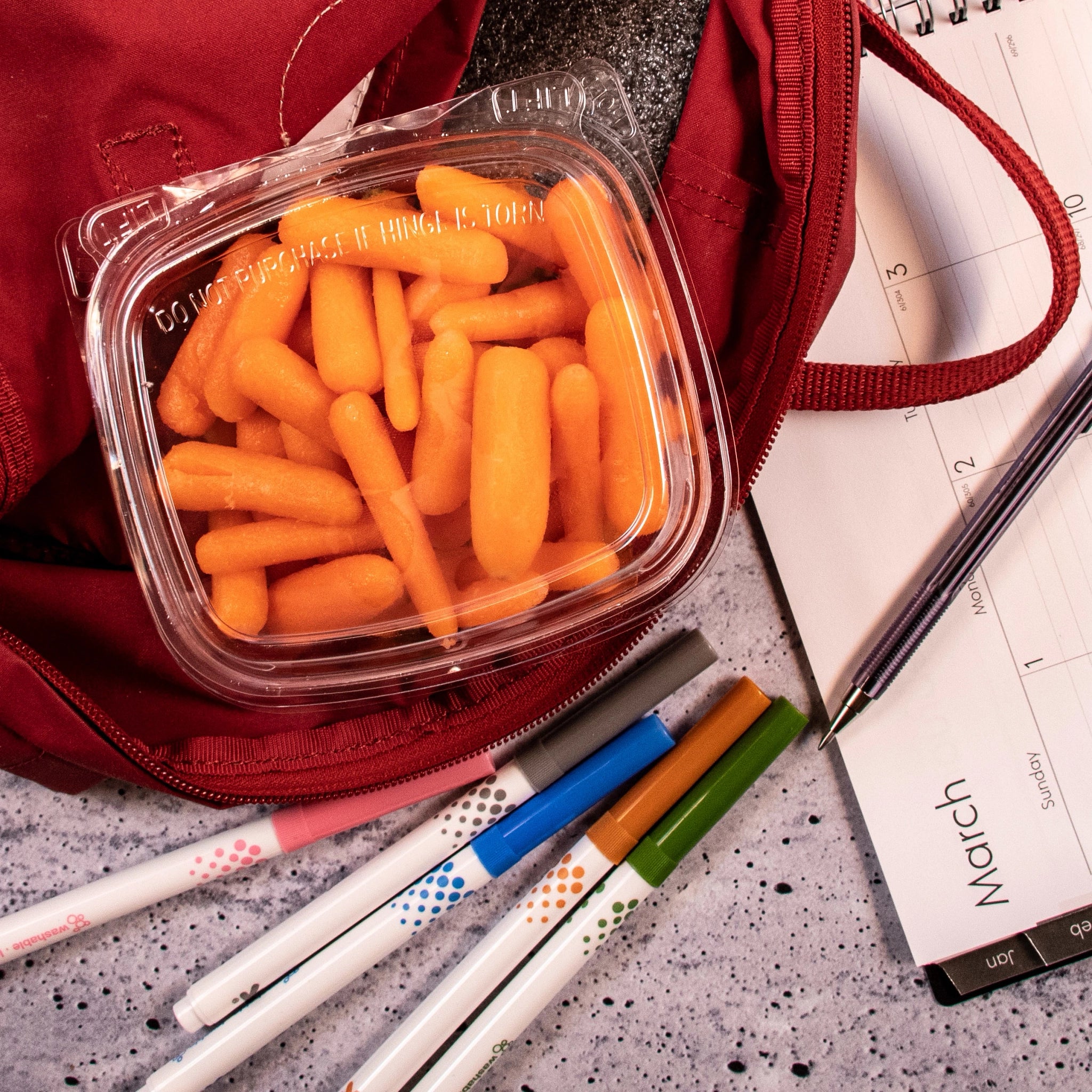 Dart CH16DED SafeSeal dome-lid container holding baby carrots in a red backpack