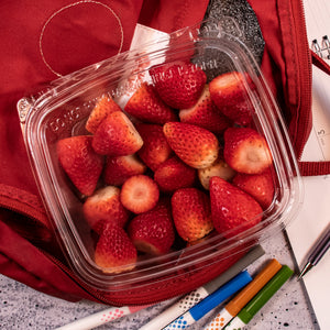 Dart CH24DED SafeSeal dome-lid container holding strawberries in a red backpack