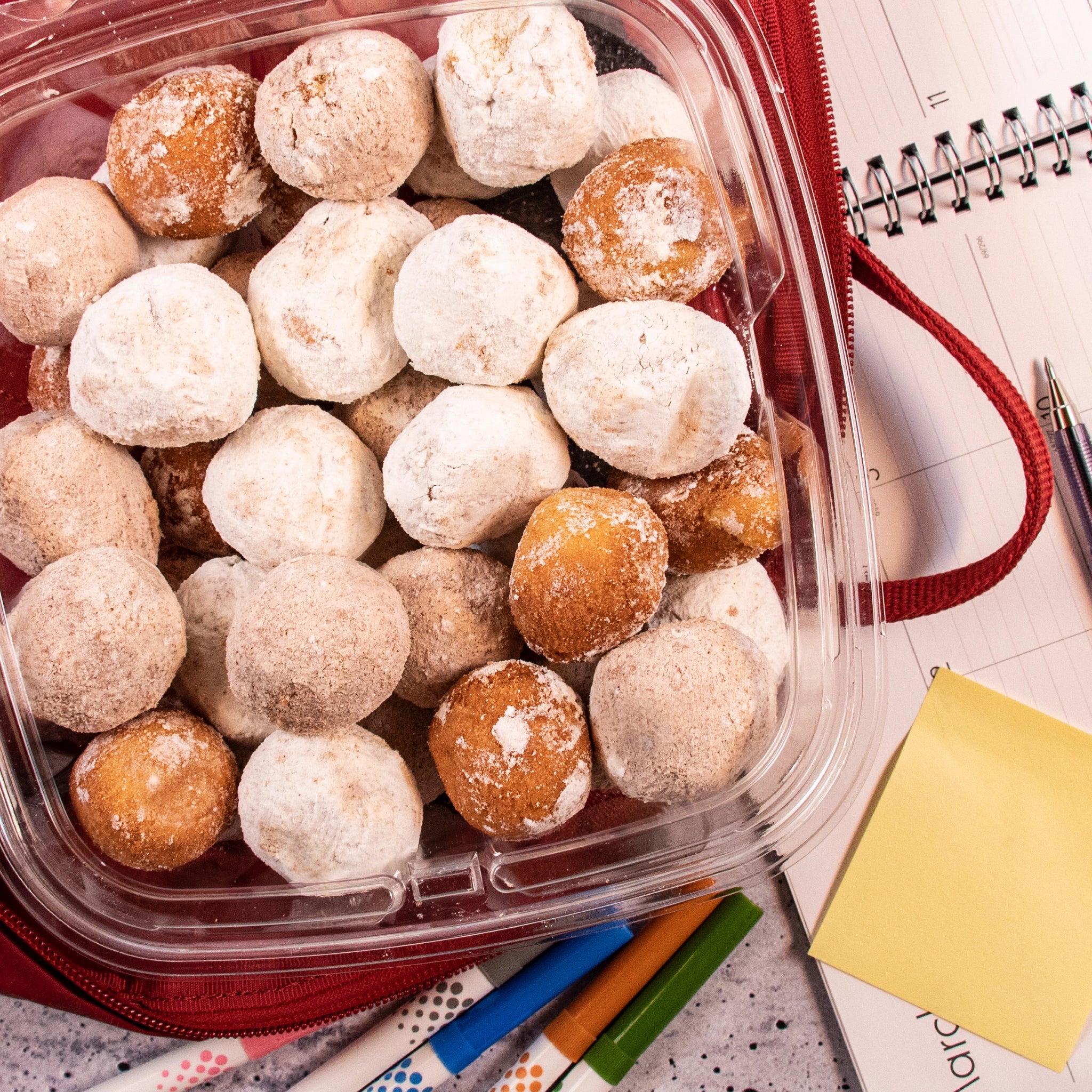 Dart CH64DEF SafeSeal container holding doughnut holes in a red backpack