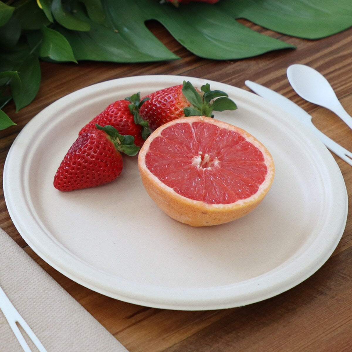 World Centric 10-inch plant-fiber plate serving fruit in a tabletop setting