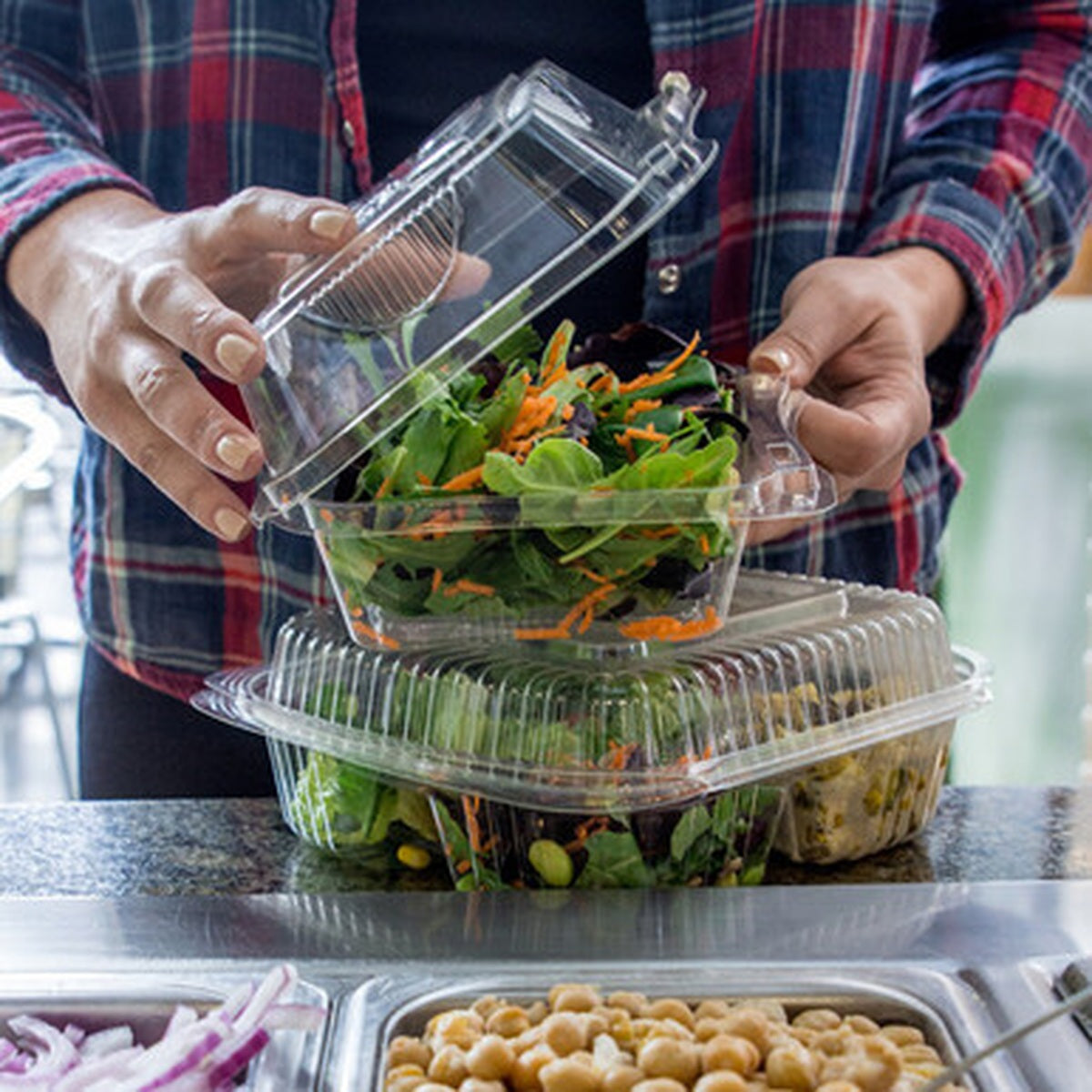 World Centric 8 inch clear PLA hinged takeout container in salad bar service