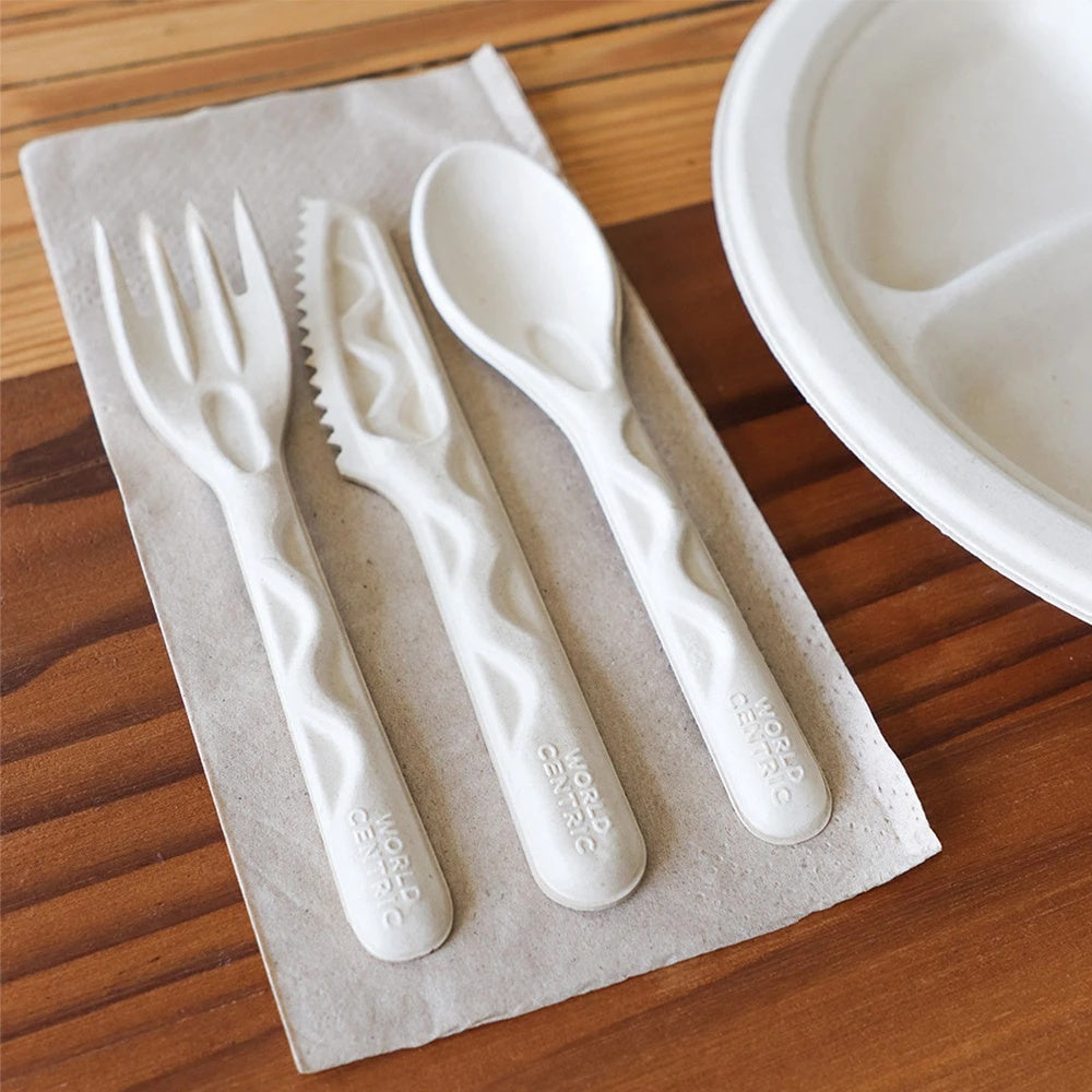 World Centric unbleached dinner napkin with fiber cutlery at a place setting