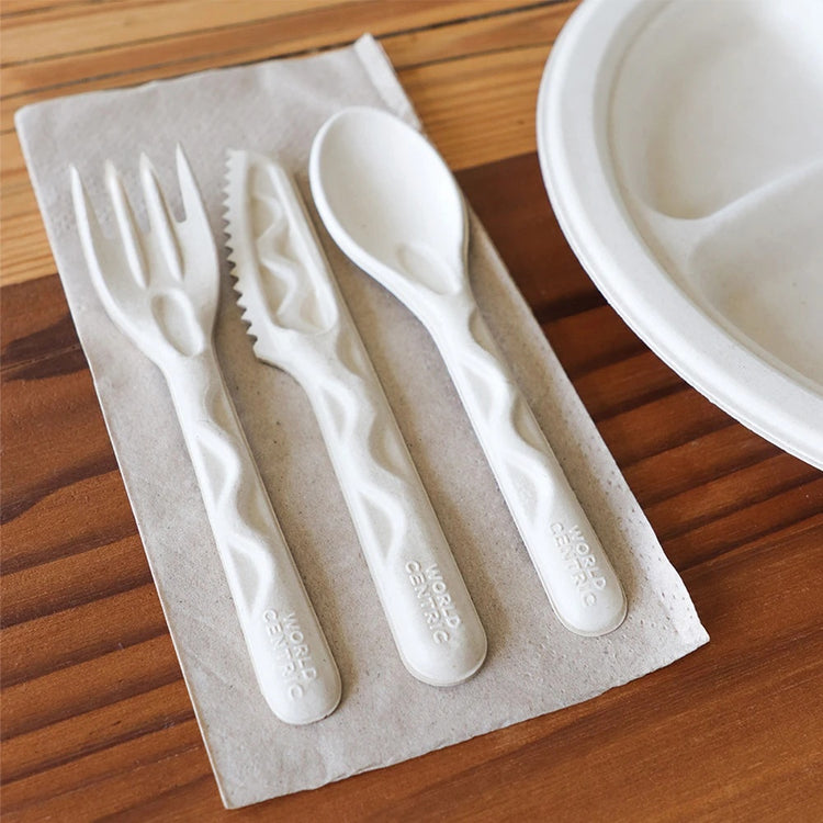 World Centric unbleached dinner napkin with fiber cutlery at a place setting