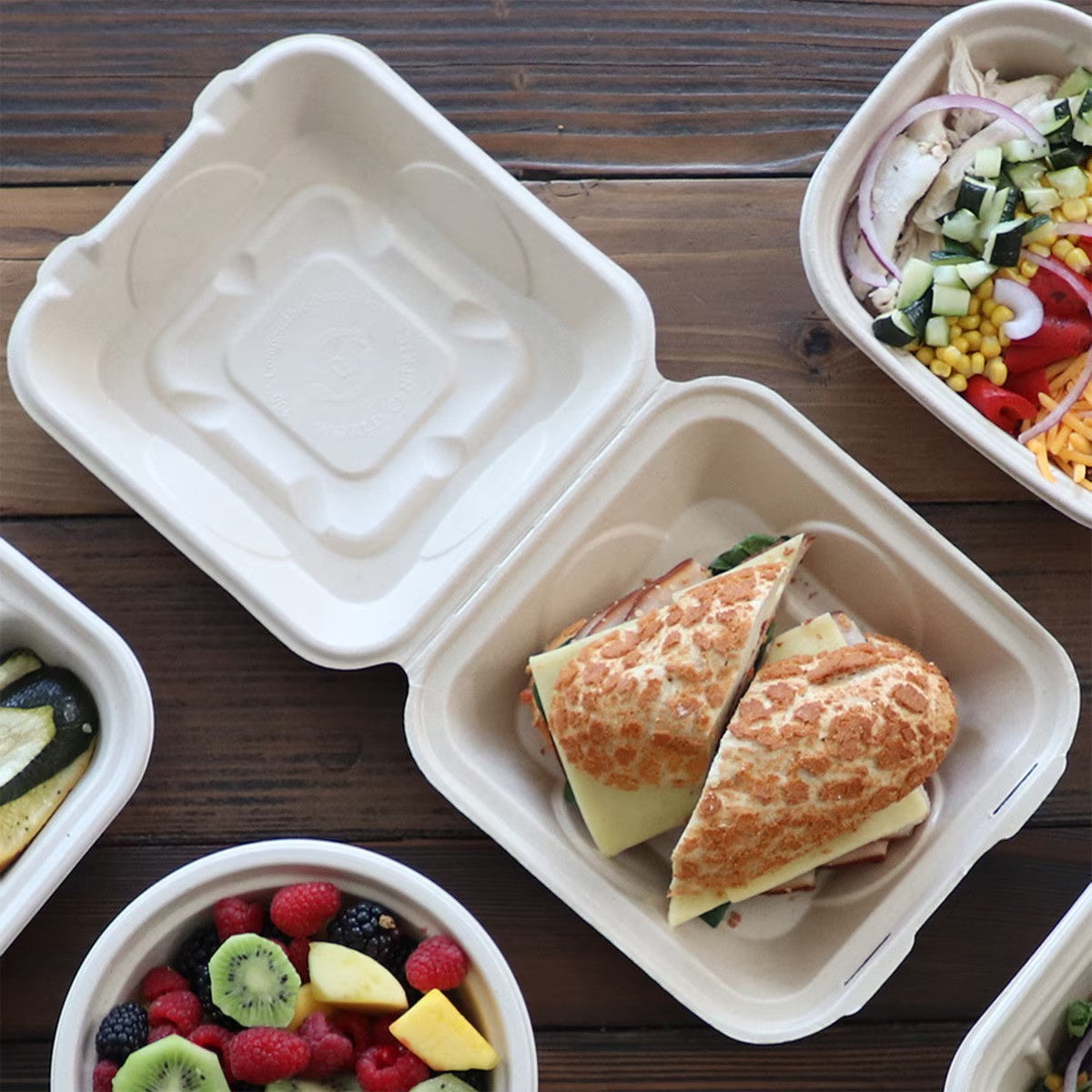World Centric TO-SC-U85-3L-LF lined fiber clamshell with sandwich in foodservice