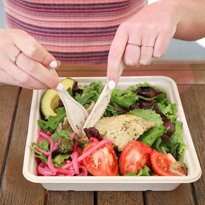 World Centric fiber knife used with a fresh salad in a fiber container
